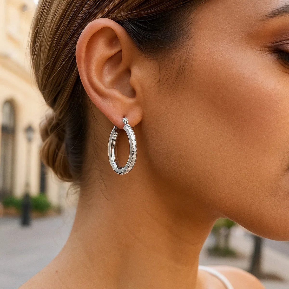 14k White Gold Diamond Cut Textured Oval Hoop Earrings.